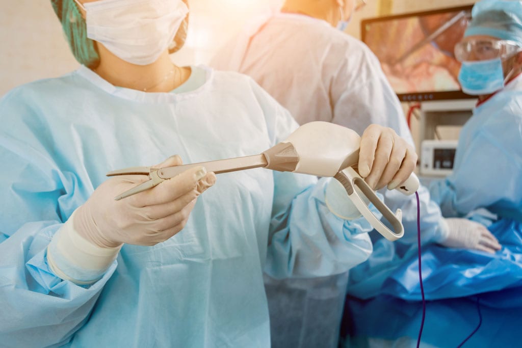 Process of Surgery Operation Using Laparoscopic Equipment. Group of Surgeons in Operating Room with Surgery Equipment.